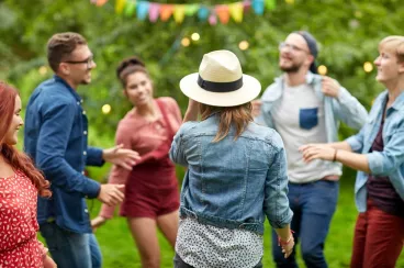 Un groupe d’amis danse dans un jardin