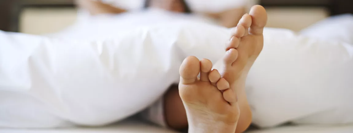 Ce matin, je reste au lit ! Une femme se repose dans son lit lors d'une grasse matinée.